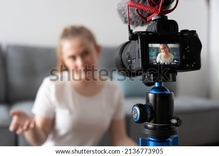 Rear view of professional slr camera recording influencer. Content creation for social media. Royalty-Free Stock Photo #2136773905
