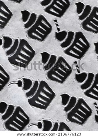 Pattern of drawing of cupcakes on flour on a black background with copy space. Cupcake with cream, cherry and candy stick on flour with copy space.