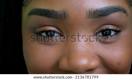 A black teen girl closing eyes in meditation person opening eye macro close-up