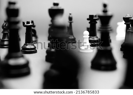 Chess pieces, black and white effect, photo frame with focus on pawn piece.