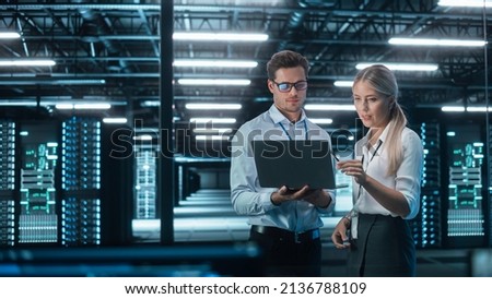 Male and Female Programmers Talking about Work, Solving Problems Together, Using Laptop Computer. Software Development  Code Writing  Website Design  Database Architecture Concept Royalty-Free Stock Photo #2136788109