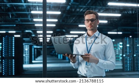 Successful Creative Director Working on Laptop Computer in Big City Office Late in the Evening. Male Business Analyst Preparing for a Meeting Discussion About Project Management Report. Royalty-Free Stock Photo #2136788115