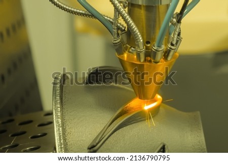 Metalworking, robotic, industrial concept. Direct metal deposition - advanced additive laser melting and powder spray manufacturing technology for repair, rebuild metal workpieces - close up