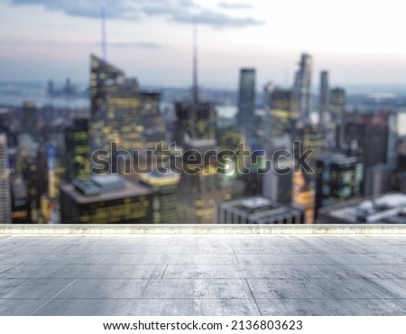 Empty concrete dirty rooftop on the background of a beautiful blurry NY city skyline at night, mock up