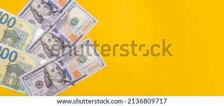 Banknotes of 100 dollars and euros on yellow background. Place for text copy space. Banner with currency. Stock market. Economic crisis. Place for text. Business plan
