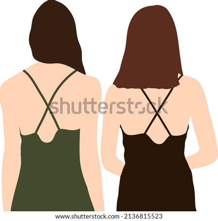 Two female friends stand with their backs next to each other