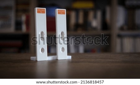 Closeup photo with positive and negative coronavirus tests inside a home
