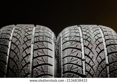 Clean car tires against dark background close up