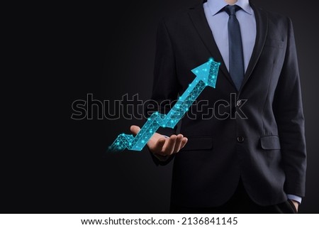 Businessman hold graph, arrow of positive growth icon.pointing at creative business chart with upward arrows.Financial, business growth concept.Low polygonal.increased sales, or increased value.