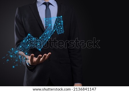 Businessman hold graph, arrow of positive growth icon.pointing at creative business chart with upward arrows.Financial, business growth concept.Low polygonal.increased sales, or increased value.
