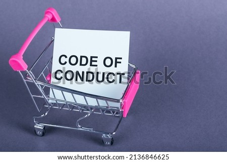 Top view of shopping cart and white card in it with Code of conduct text on purple background. Business and code of conduct concept.