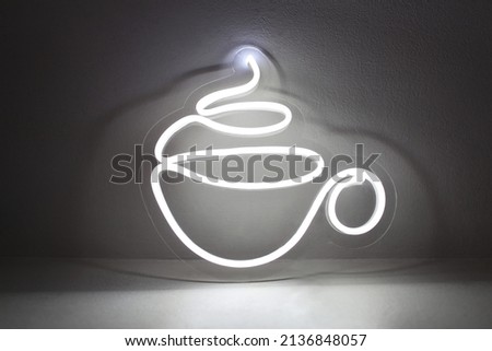 Trendy style. White mug of tea or coffee neon sign on background. 
 Neon sign. Custom neon. Decor. Neon concept.
