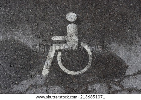 Wheelchair symbol on asphalt in a parking lot