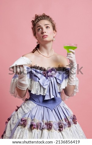 Despair. Vintage portrait of young adorable girl in image of medieval royal person in renaissance style dress isolated on pink background. Comparison of eras, beauty, history, art, creativity.