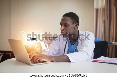 African American doctor using computer check patient data document