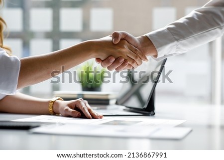 Close-up view of business partnership handshake, Photo of two businessman handshaking process. Successful deal after great meeting. Horizontal, flare effect, blurred background handshake concept. 