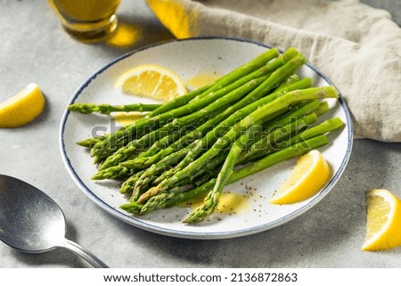 Homemade Organic Steamed Asparagus with Lemon and Olive Oil Royalty-Free Stock Photo #2136872863
