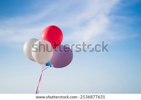 Multi colour balloons on blue sky background