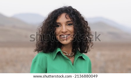 Close-up photo of Positive Woman -Smiling Emotions Girl Eyes Looking at Camera. Outdoor in nature.