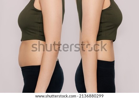 Young woman in profile with a belly with excess fat and toned slim stomach with abs before and after losing weight isolated on a beige background. Result of diet, liposuction, training Royalty-Free Stock Photo #2136880299