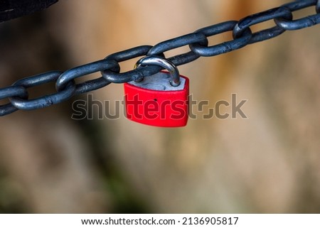 Love symbol, old rusty red padlock hanging on a chain 