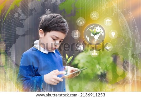 School kid using tablet research on internet about world population, Ecology and Environmental,Boy doing online learning,Geography with Double exposure growth futuristic young green tree on globe map