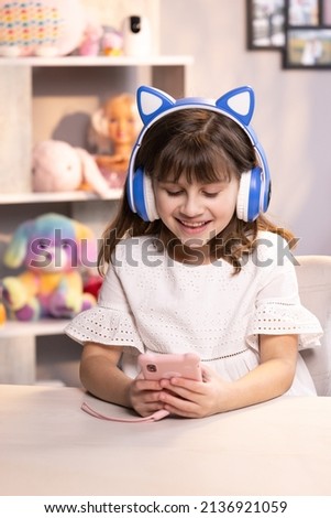 Smiling young woman blogger subscribing new social media, buying in internet, ordering products online in apps. Happy caucasian little teen girl holding cell phone using smartphone device at home