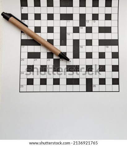 pen made of recycled material lies on empty crossword puzzles top view free space isolated Royalty-Free Stock Photo #2136921765