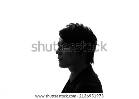 Silhouette of thinking asian businessman. Royalty-Free Stock Photo #2136951973
