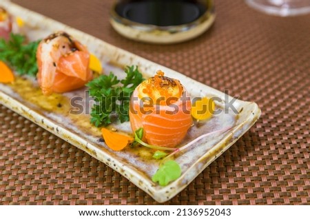 Platter decorated with different flavors of elegant  sushi. Selective focus.