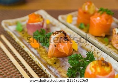 Platter decorated with different flavors of elegant  sushi. Selective focus.