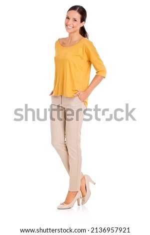 Shes everybodys woman. A casually dressed young woman standing with her hands in her pockets. Royalty-Free Stock Photo #2136957921
