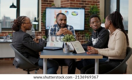 Team of african american businesspeople meeting in boardroom office to discuss strategy and work plan, creating financial project with statistics. Colleagues doing teamwork to analyze sales data. Royalty-Free Stock Photo #2136969367