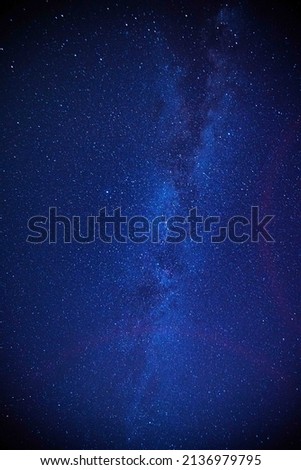 Astro photography in a desert nightscape with milky way galaxy. The background is stary celestial bodies in astronomy.
