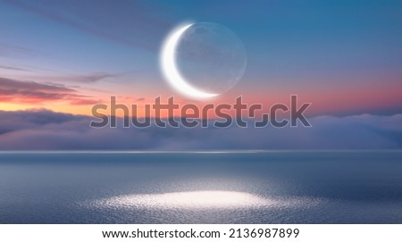 Ramadan Concept - Abstract background with Crescent moon over the sunset clouds Royalty-Free Stock Photo #2136987899