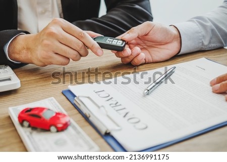 Sale agent deal to agreement successful car loan contract with customer and sign agreement contract Insurance car concept.