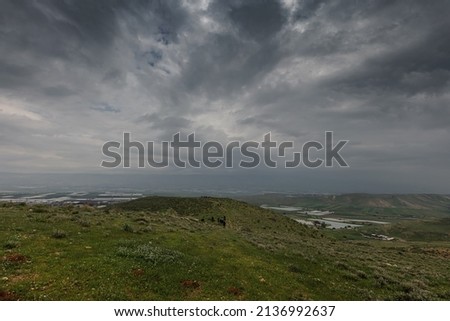 landscape in rainy weather, a group of people far away  Royalty-Free Stock Photo #2136992637