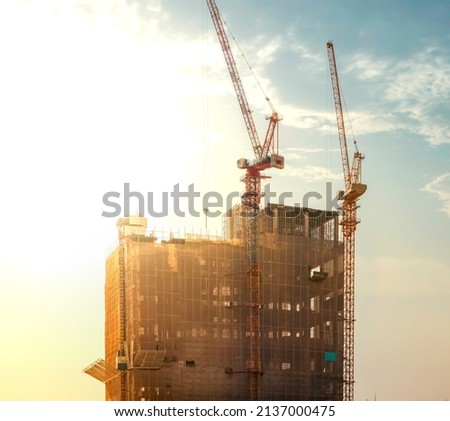 those tower cranes were used to create built and in the picture, there was a construction site with sunshine.