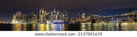 Panorama of  Brooklyn Bridge and panoramic night view of downtown Manhattan after sunset in New York City, USA