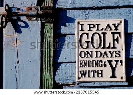 Golf sign at old wooden door