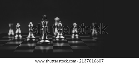 Close-up king chess standing first on chess board concepts challenge or battle fighting of business team and leadership strategy and organization risk management or team player. Royalty-Free Stock Photo #2137016607