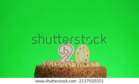 Cake with lighted candle number 20. Green screen background. Isolated.