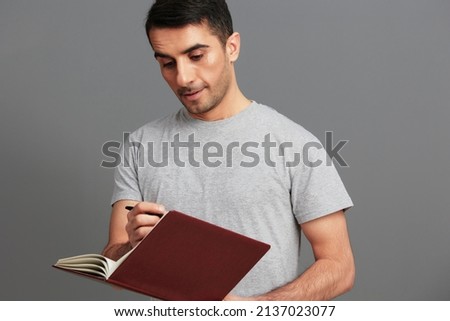 Cheerful man with notepad training emotions isolated background