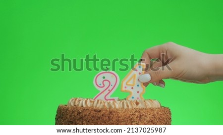 Cake with lighted candle number 24. Green screen background. Isolated.