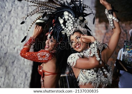 For the joy of samba. Shot of two beautiful samba dancers performing in a carnival. Royalty-Free Stock Photo #2137030835