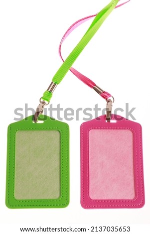 Two blank badge mockup by color orange pink and green isolated on white. Plain empty name tag mock up hanging on neck with string, name tag