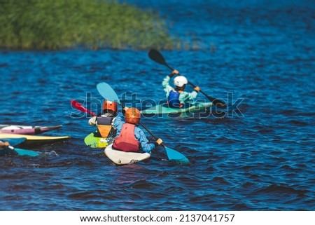 Kids learn kayaking, canoeing whitewater training in the lake river, children practicing paddling, yound kayakers in a summer camp
 Royalty-Free Stock Photo #2137041757