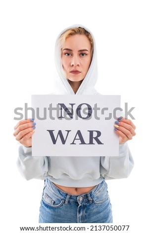 A young woman holds a no war poster on a white background