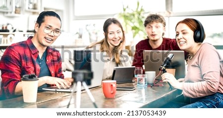 Happy students sharing content on streaming platforms with digital web cam - Modern life style concept with guys and girls speaking and having fun vlogging live feeds on social media - Bright filter Royalty-Free Stock Photo #2137053439