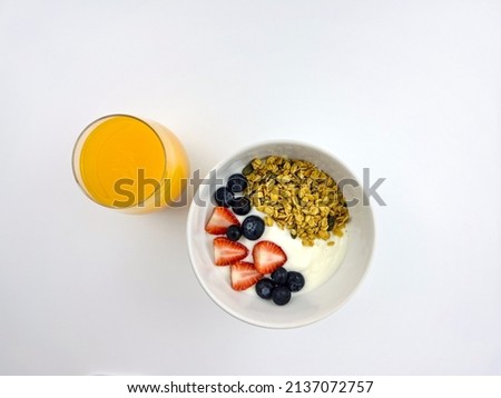 Granola in yogurt Strawberry, Blueberry and Orange Juice, clipping path isolated white background 
